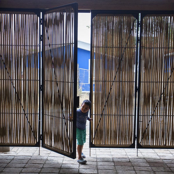Photograph of a child entering a dwelling in Ecuador. Location is marked as the Cultural Center. Courtesy of ArchDaily and Photographer Santiago Oviedo.