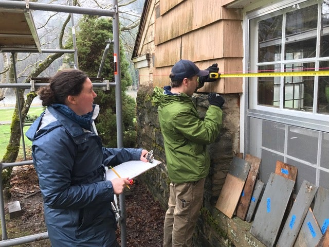 students work on wood window preservation