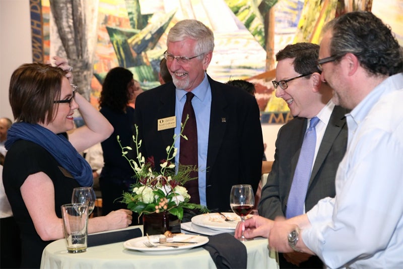 Provost Scott Coltrane and President Michael Schill celebrate with Kate Mondloch