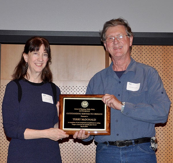 Renee Irvin presents plaque to Terry McDonald