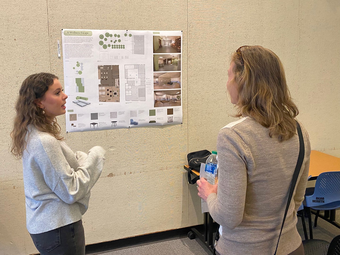 female student presenting her work to a staff member from The Arc