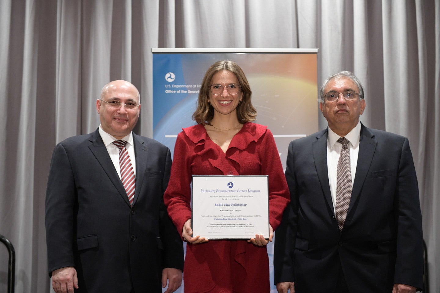 Sadie Mae in Washington DC receiving a certificate from 2 men in suits