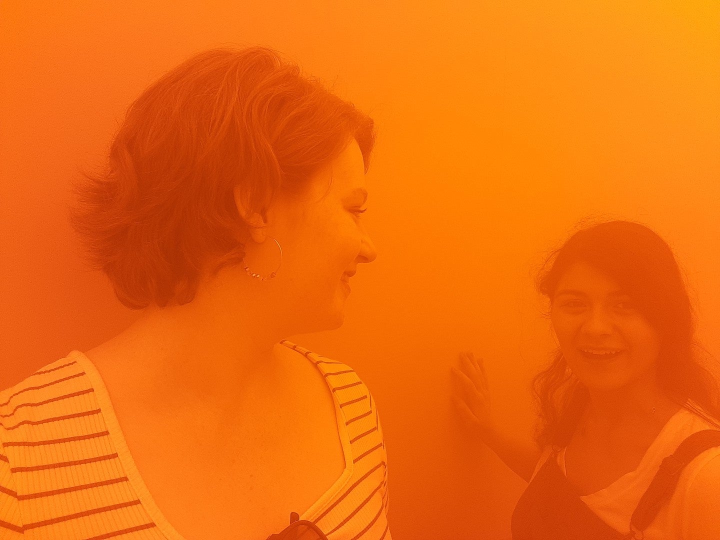 Photo of Two Art History Students in London. Photograph shows two students in an orange cloud.