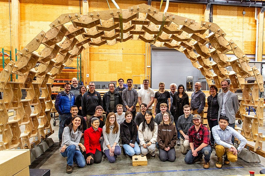students standing in front of arch