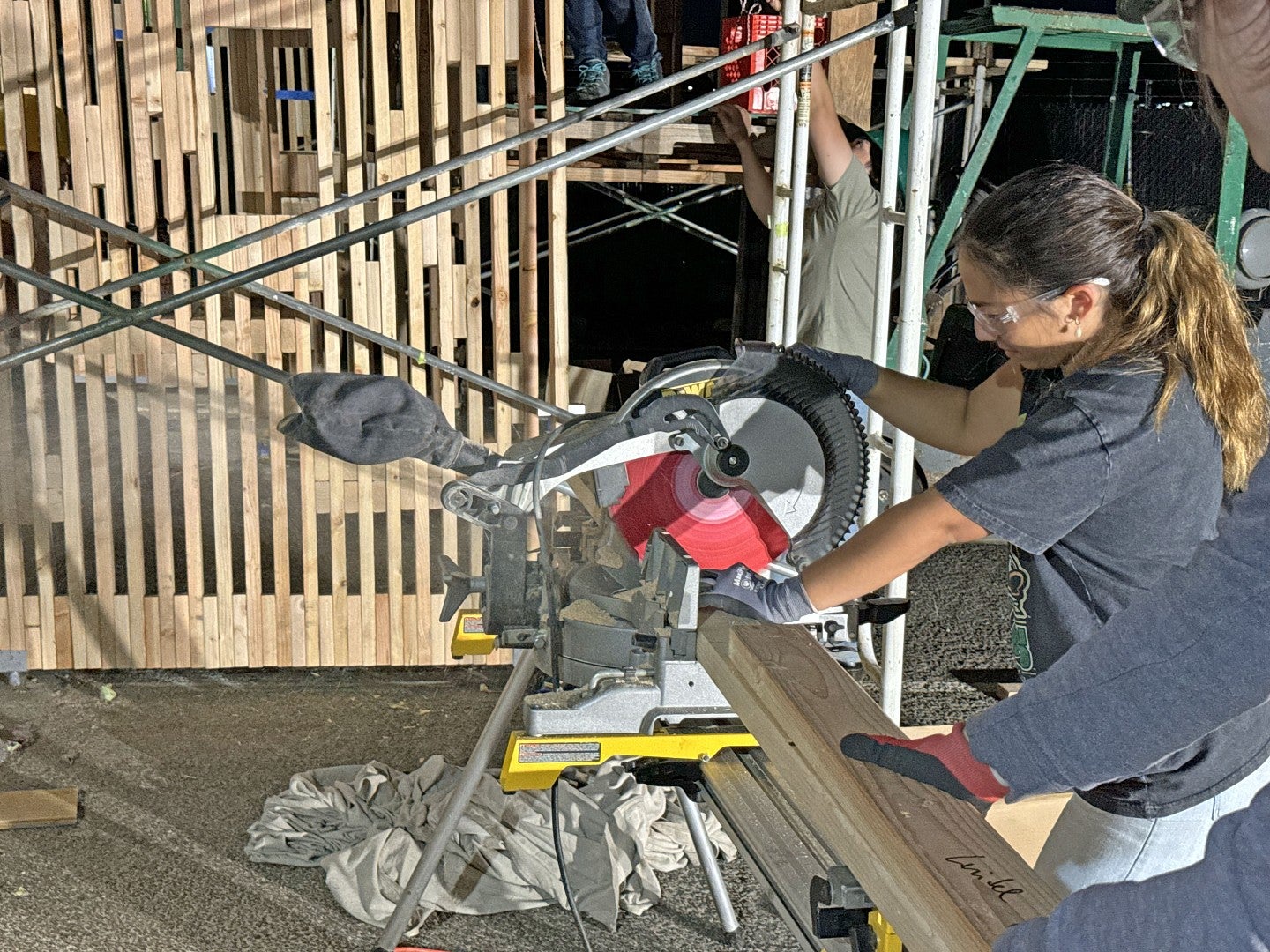 BDI student cutting lumber. 