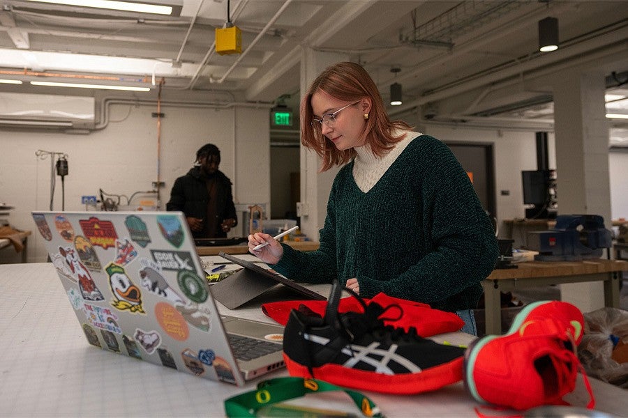 Lulu West designing shoes in an SPD workshop. 