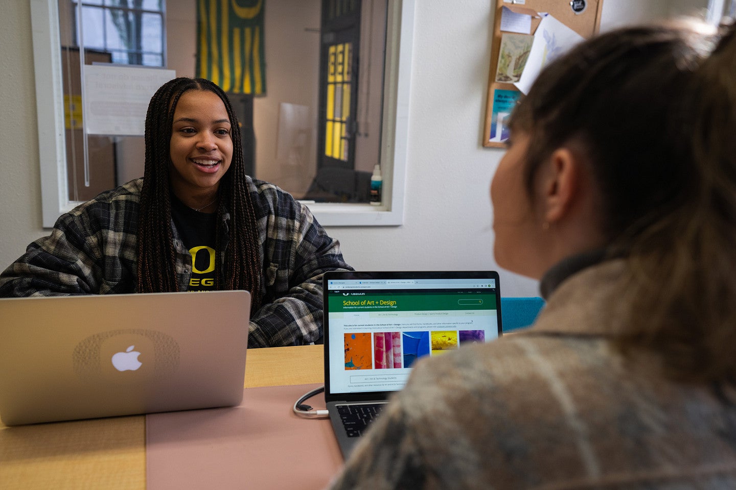 Photograph of a student working with an advisor.