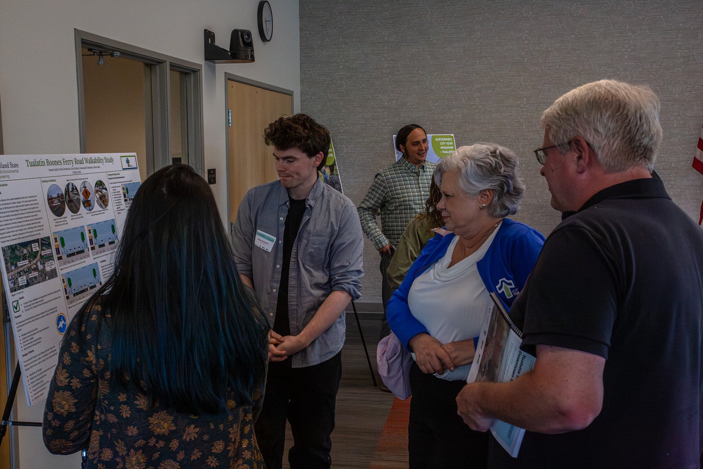 Students talk with community members about SCYP project findings.