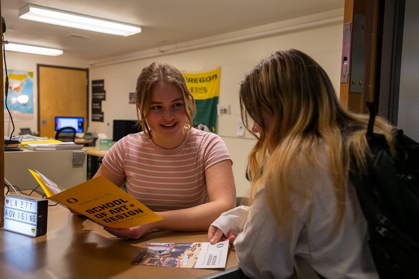 Photograph of two students meeting. 