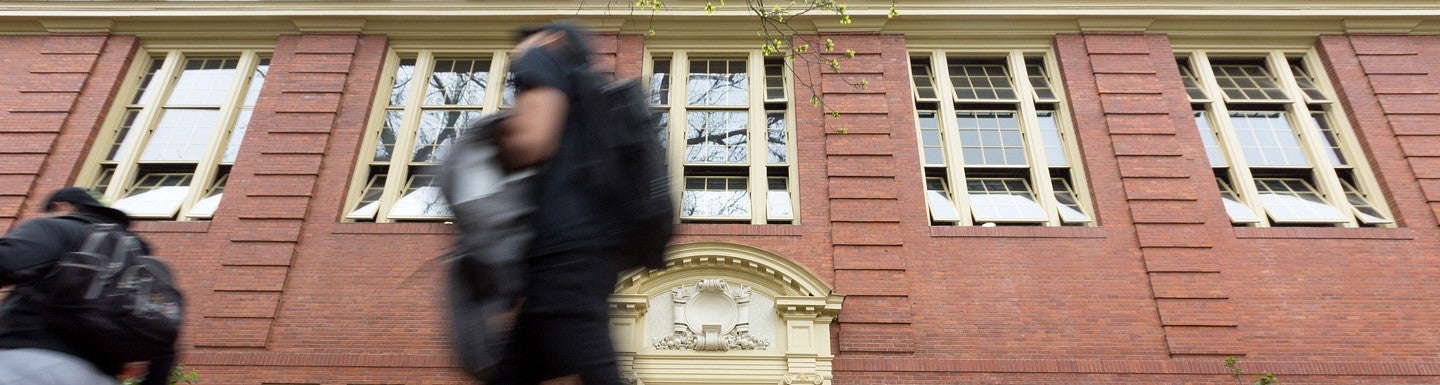 students walk by windows