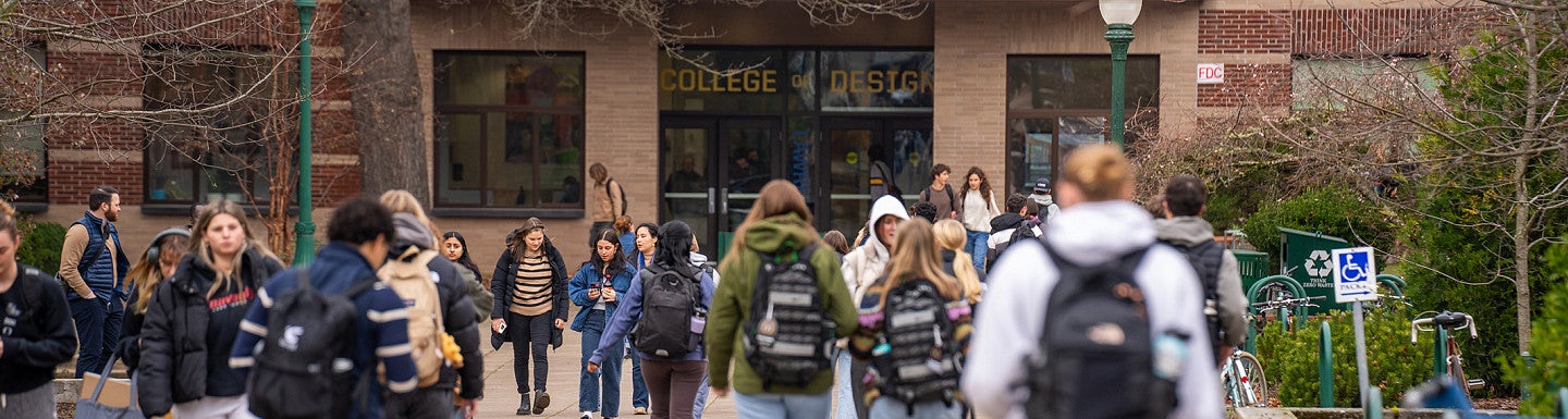Photograph of students walking into Lawrence Hall. 