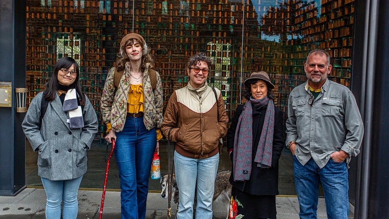 Group photo in front of copper urns