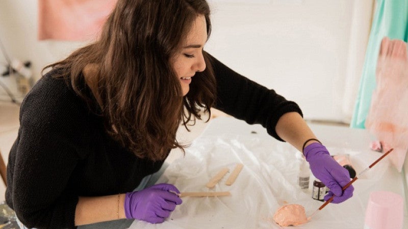 Master of Fine Arts candidate Aja Segapeli works in her art studio on campus