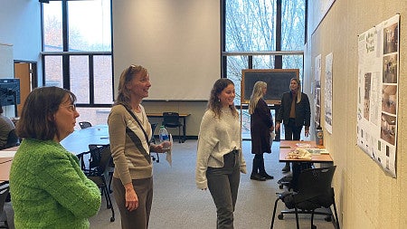 female student presenting her work to a staff member from The Arc and professor Linda Zimmer