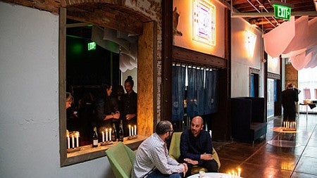 people sitting at candle lit table