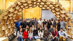 students standing in front of arch