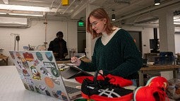 Lulu West designing shoes in an SPD workshop. 