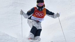 Photograph of a skier going down a slope at the Winter Games. 