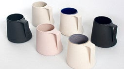 Various evolutions of Aileen Tran’s basic cup design customize colors and glazes. Photo by Aileen Tran.