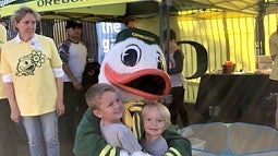 UO Duck hugs children