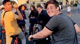 Student Finley Heeb biking with other students in European city