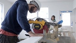 person sawing wood