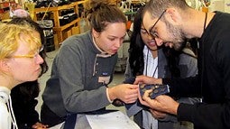 students looking at fabric swatch 