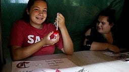 Student with LED light necklace