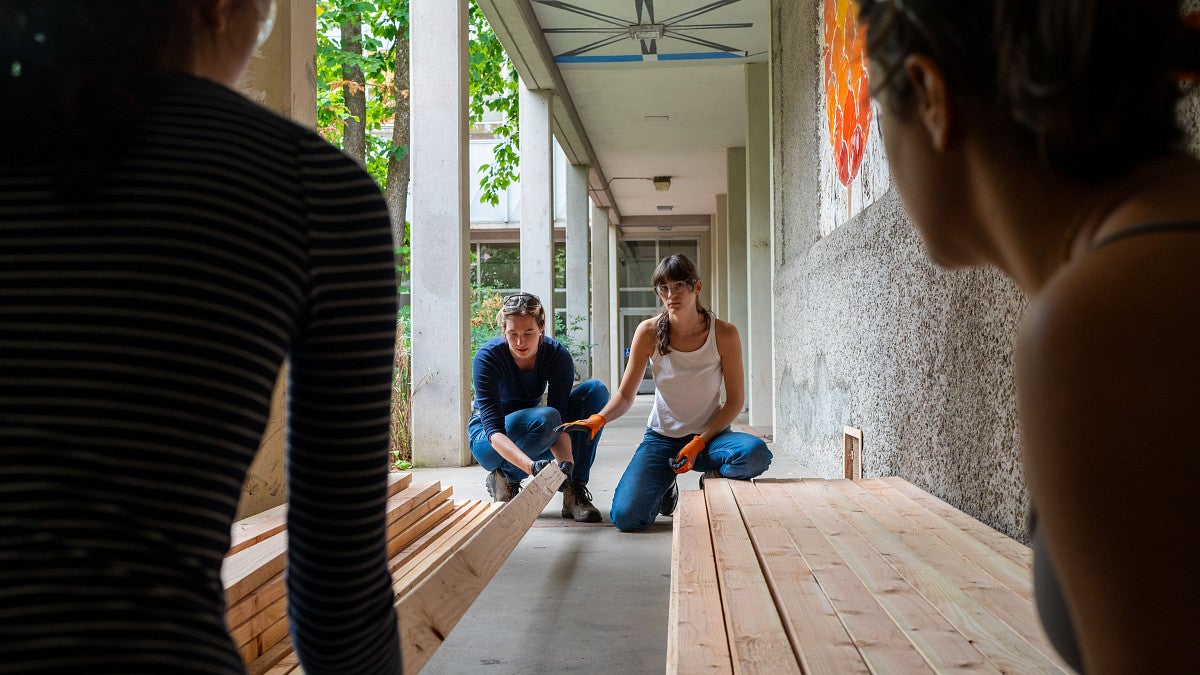 24 Bruton Design Intensive shot of students working with work.