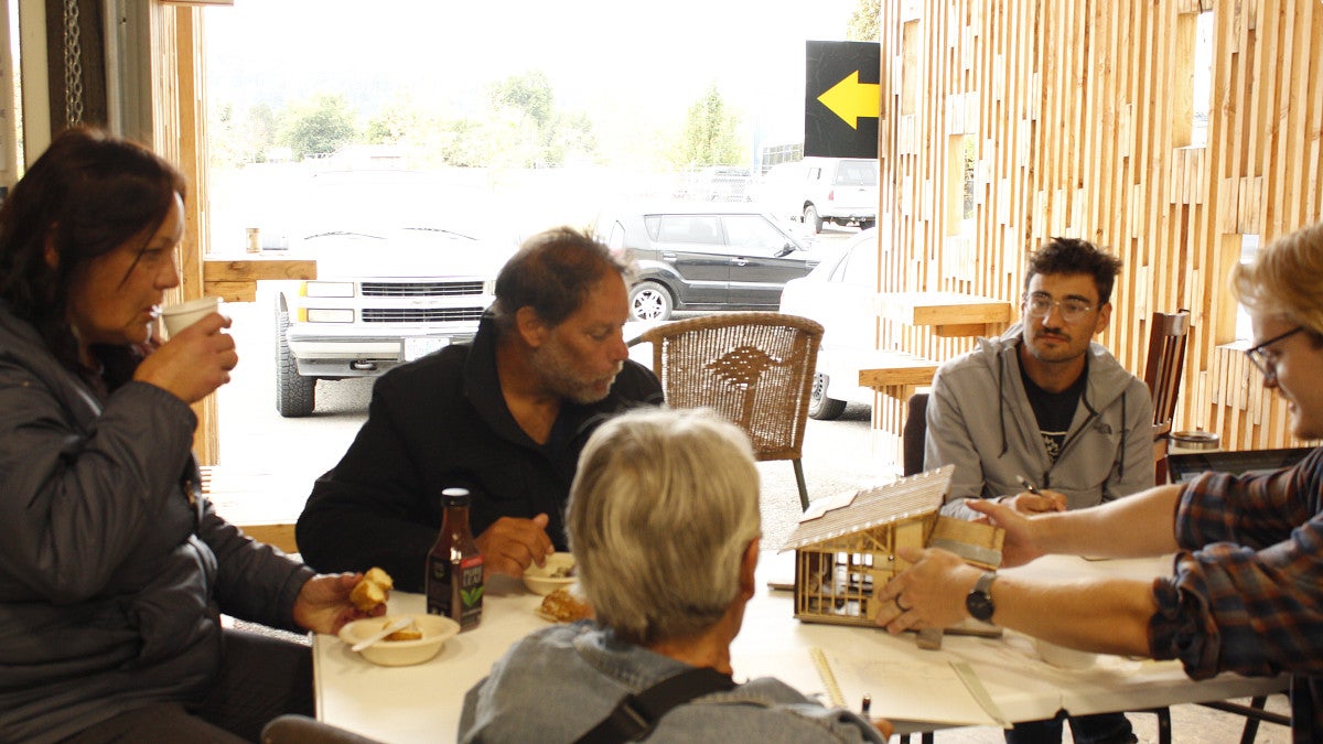 Photograph of Students working with community members.
