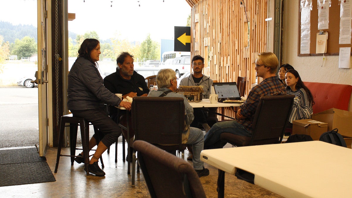 Photograph of community members talking with a group of students. 