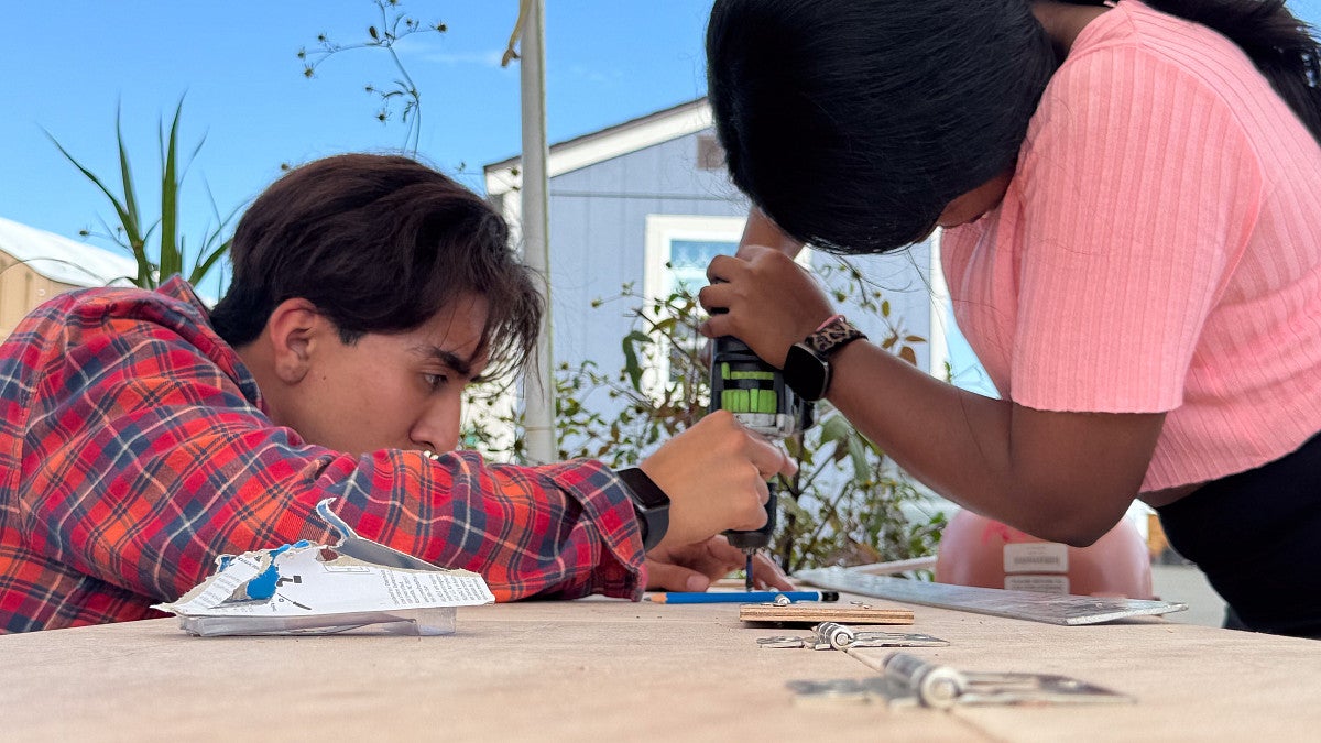 Students work on wood. 
