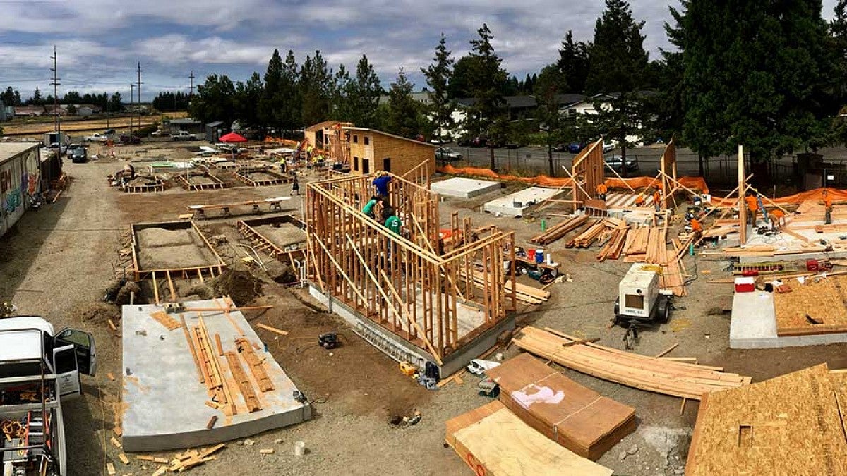 Tiny houses under construction in August in Emerald Village. Michael Fifield’s design is at center.