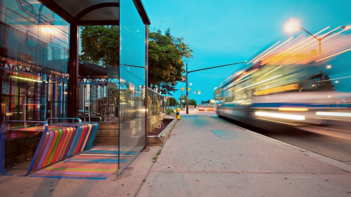 bus stop with bus driving by