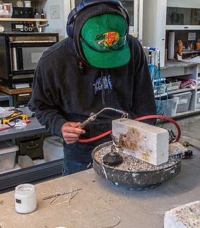 Photograph of Ignatius working in the jewelry studio