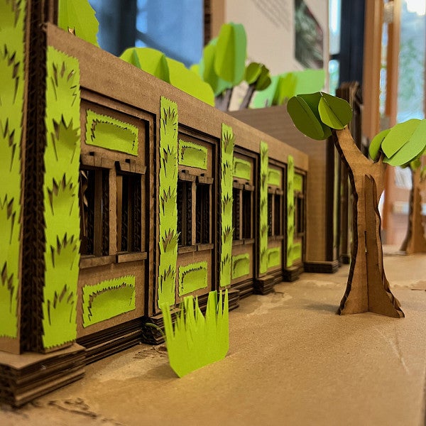 3D Cardboard Model of a "Living Building," a building co-existing with trees and plants built into the design.