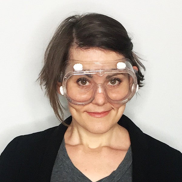 Photograph of Nina Pavlich looking into the camera with safety goggles over her eyes. 