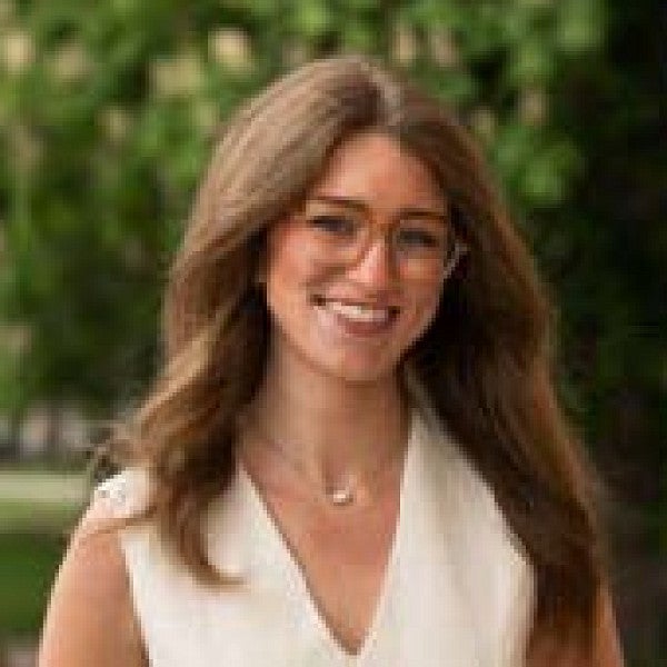 Photograph of a woman smiling into the camera. 