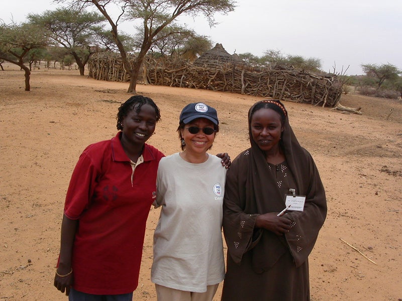 Rogers with two local villagers in Darfur, Sudan, in 2002.