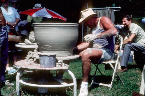 Jay Lindsay throws one of his large planters at an outdoor craft fair.