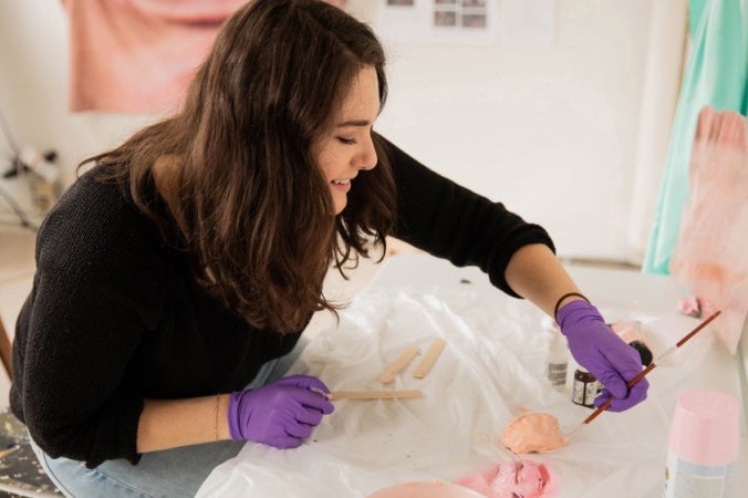 Master of Fine Arts candidate Aja Segapeli works in her art studio on campus