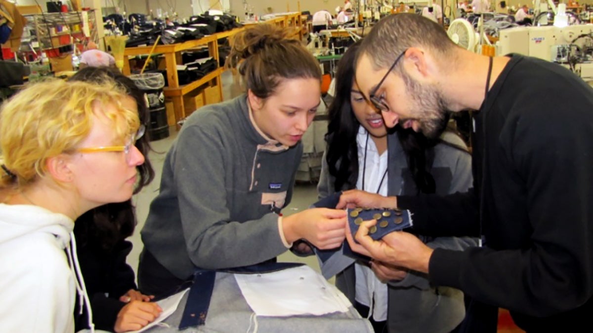 students looking at fabric swatch 