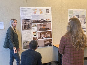 female student presenting her work to a staff member from The Arc and an architect reviewer