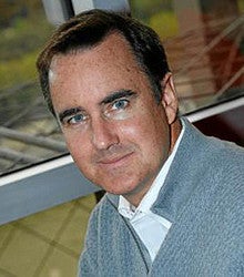 Photo of Mark Gillem, a man with short dark hair and blue eyes looking into the camera.