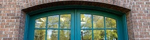 green doors in brick building