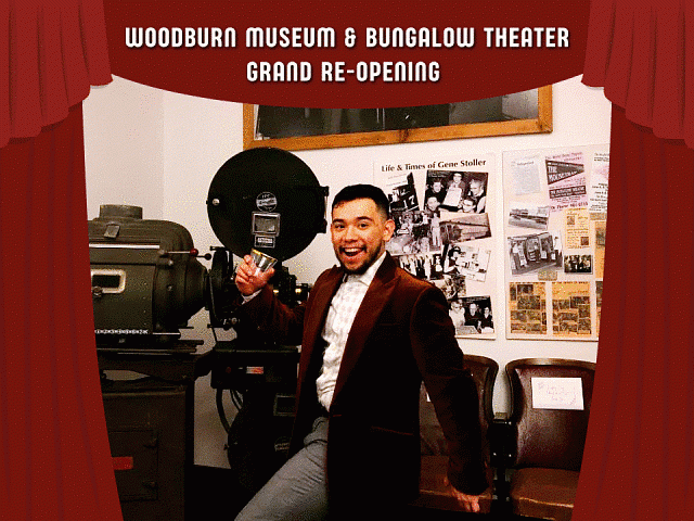 Photograph of Beny posing for the Woodburn Museum & Bungalow Theater Grand Re-Opening. Shows an individual posing in front of film and theater items.