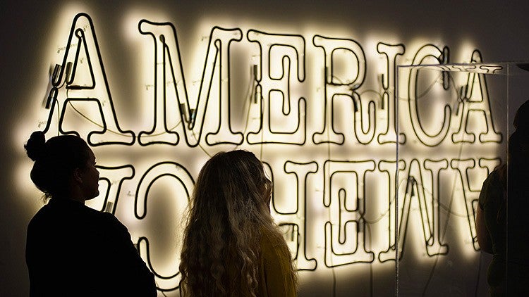 students look at America sign at the Jordan Schnitzer Museum of Art