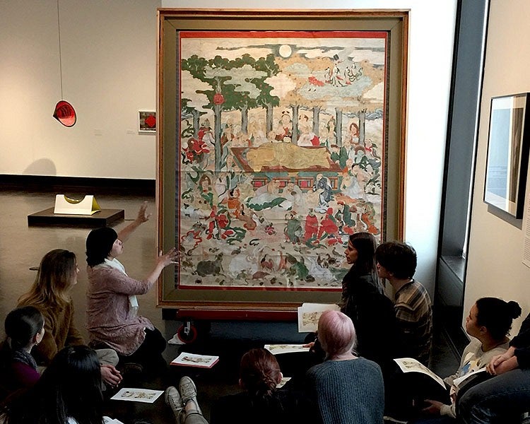 students learn about artwork depicting the death of Buddha