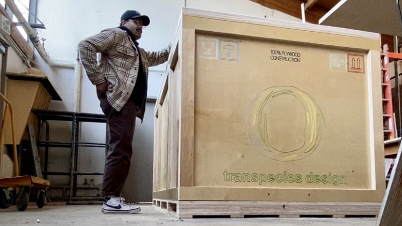 Yash with crate that contains final designs for ECC Biennale