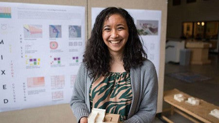 Ali Lau, an architecture graduate student, holds a model of her project. She received four nominations to be featured in an Emerald edition honoring women in the UO community for Women's History Month. (Phillip Quinn/Emerald)